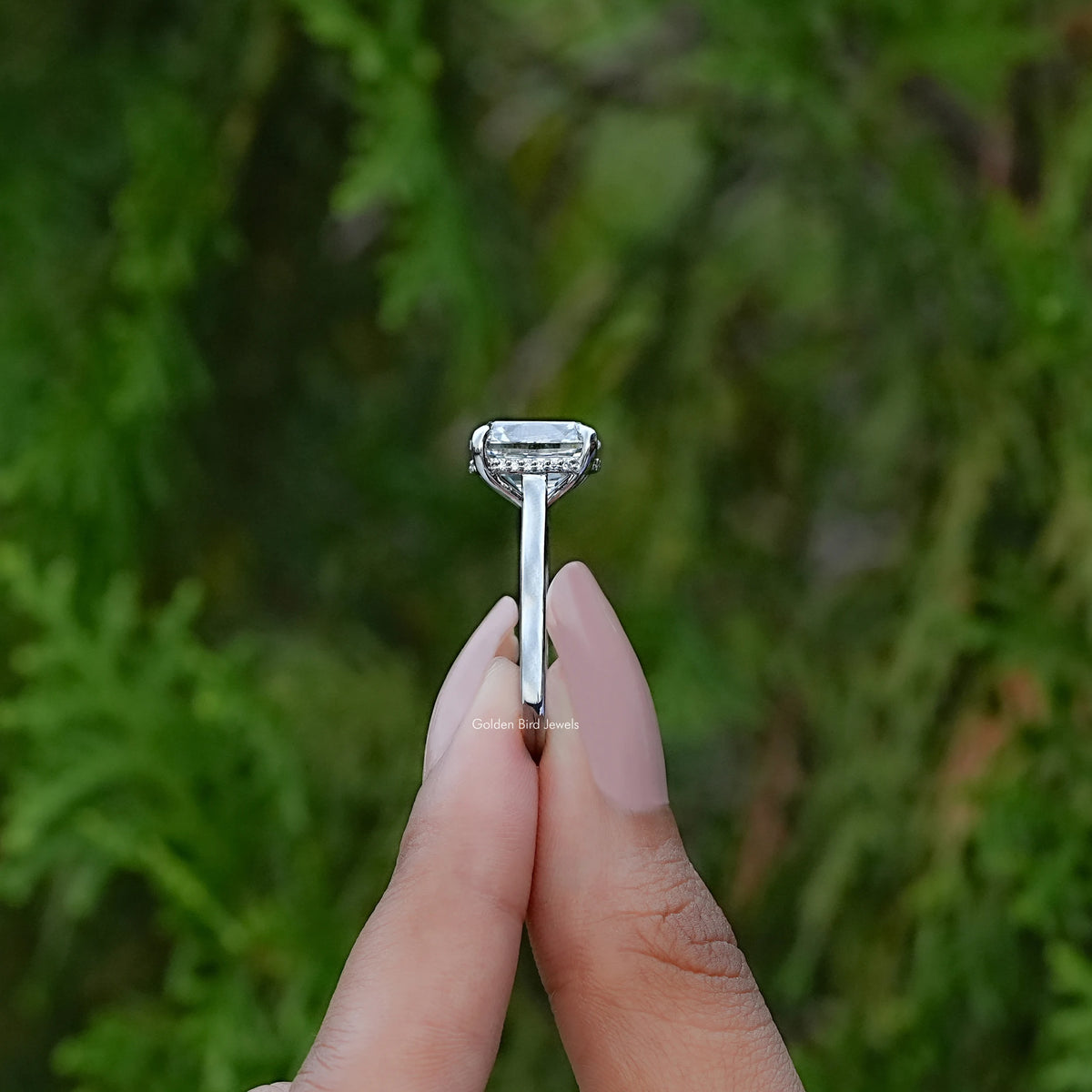 Side View of Cushion Cut Halo Lab Diamond Engagement Ring In two fingers