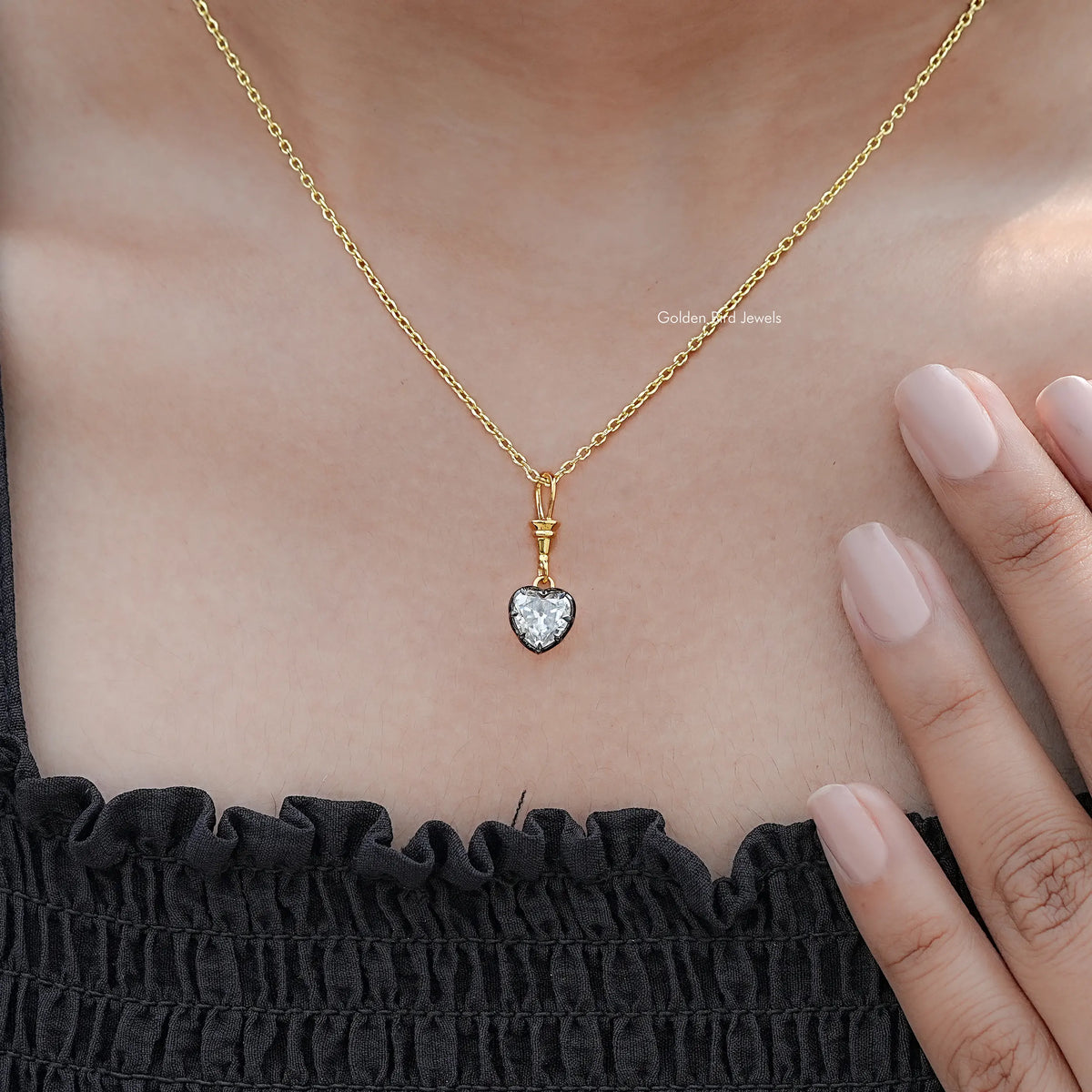 In hand Showing View Of Old Mine Heart Shaped solitaire pendant