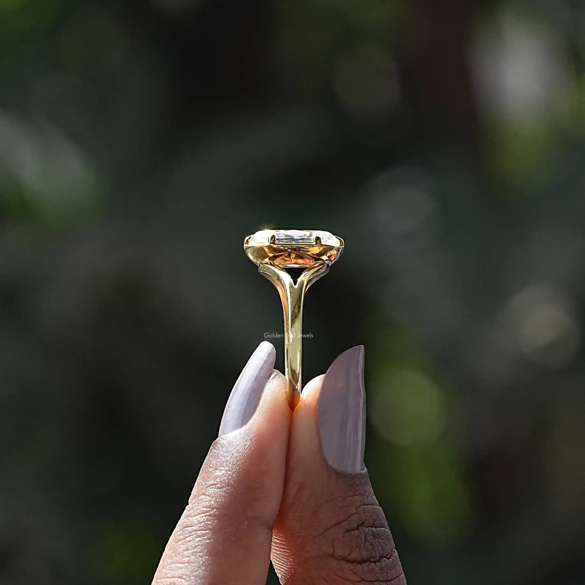 Side View of Old Mine Moval Cut Moissanite Ring In two fingers