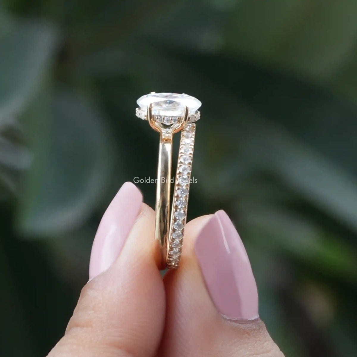 Side View of Oval Cut Moissanite Hidden Halo Ring Set In two fingers