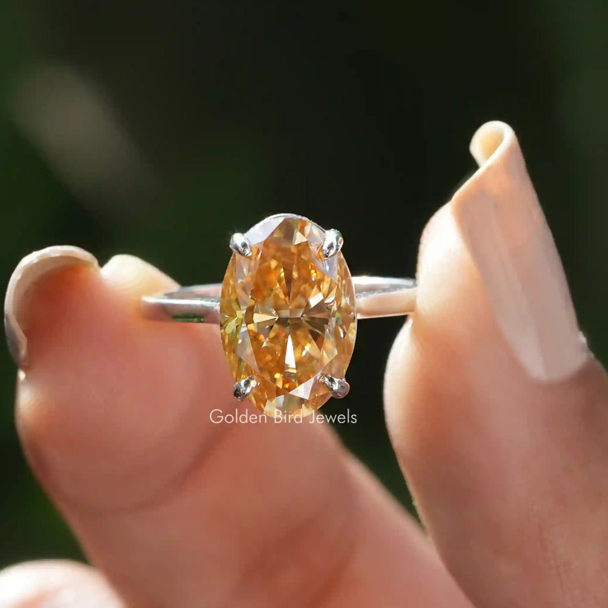 Front View of Oval Cut Moissanite Solitaire Engagement Ring In two Fingers