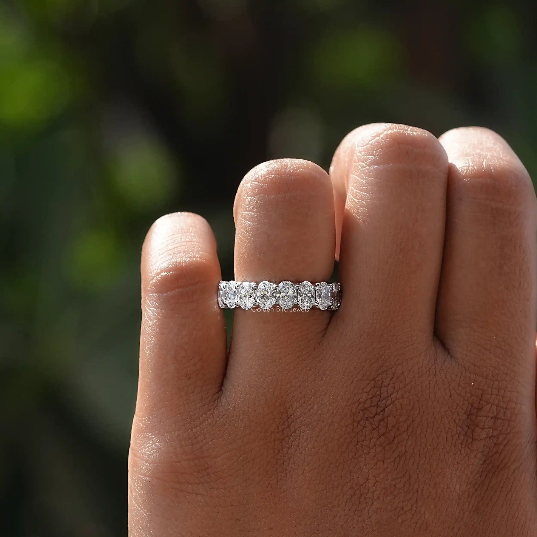 View of Oval Cut Lab Grown Wedding Band In Finger