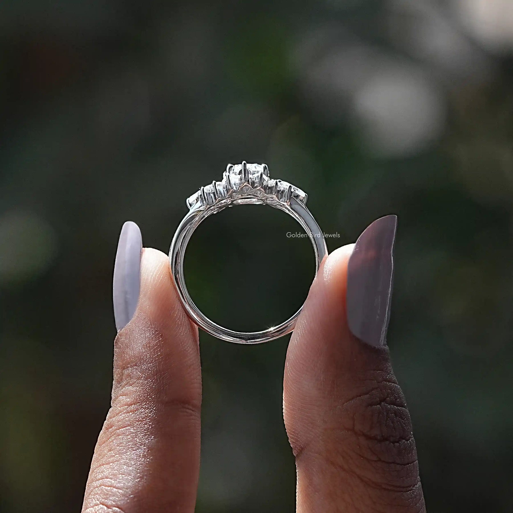 Back View of Oval Cut Moissanite Cluster Ring In two fingers