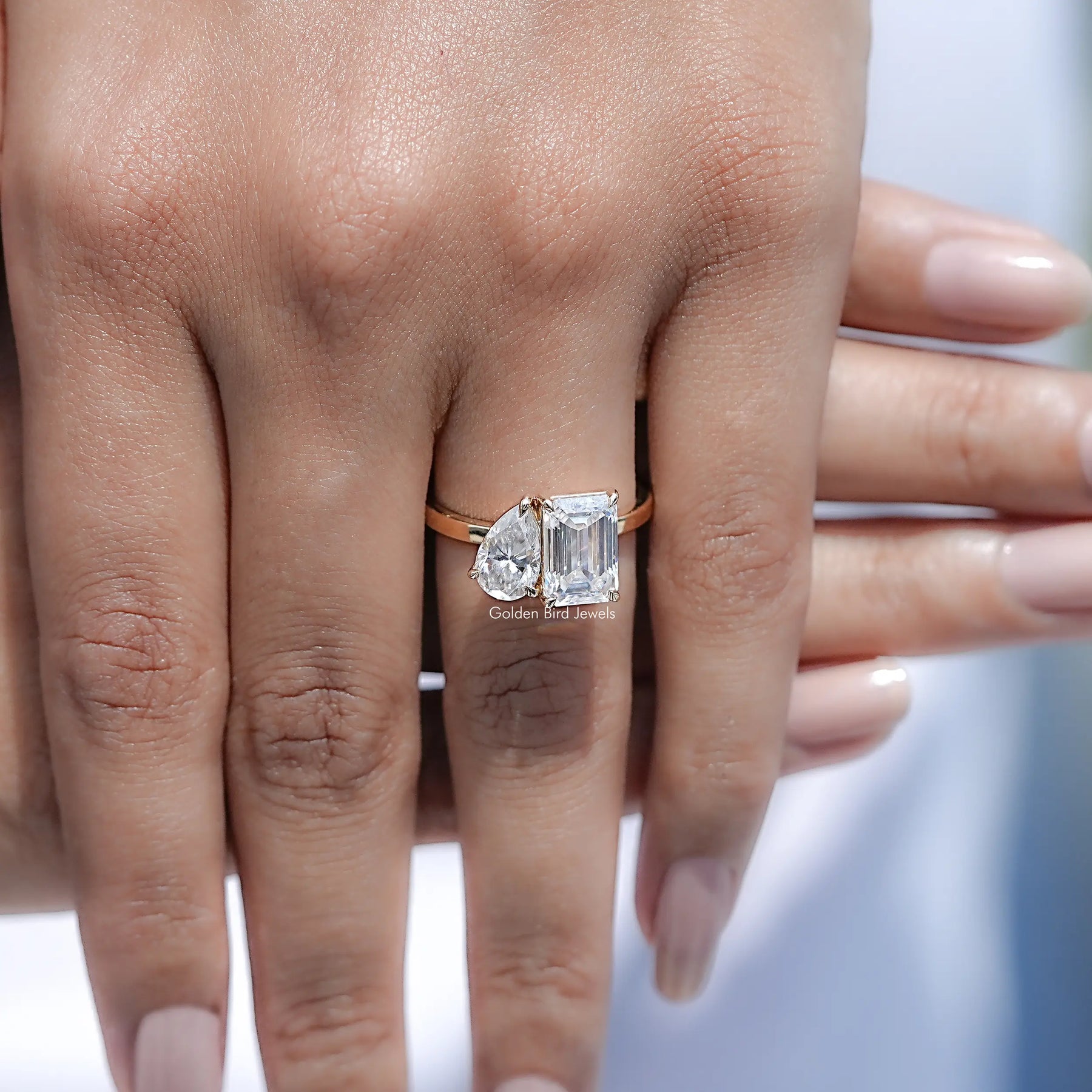 Close view of Pear And Emerald Cut Moissanite Solitaire Ring
