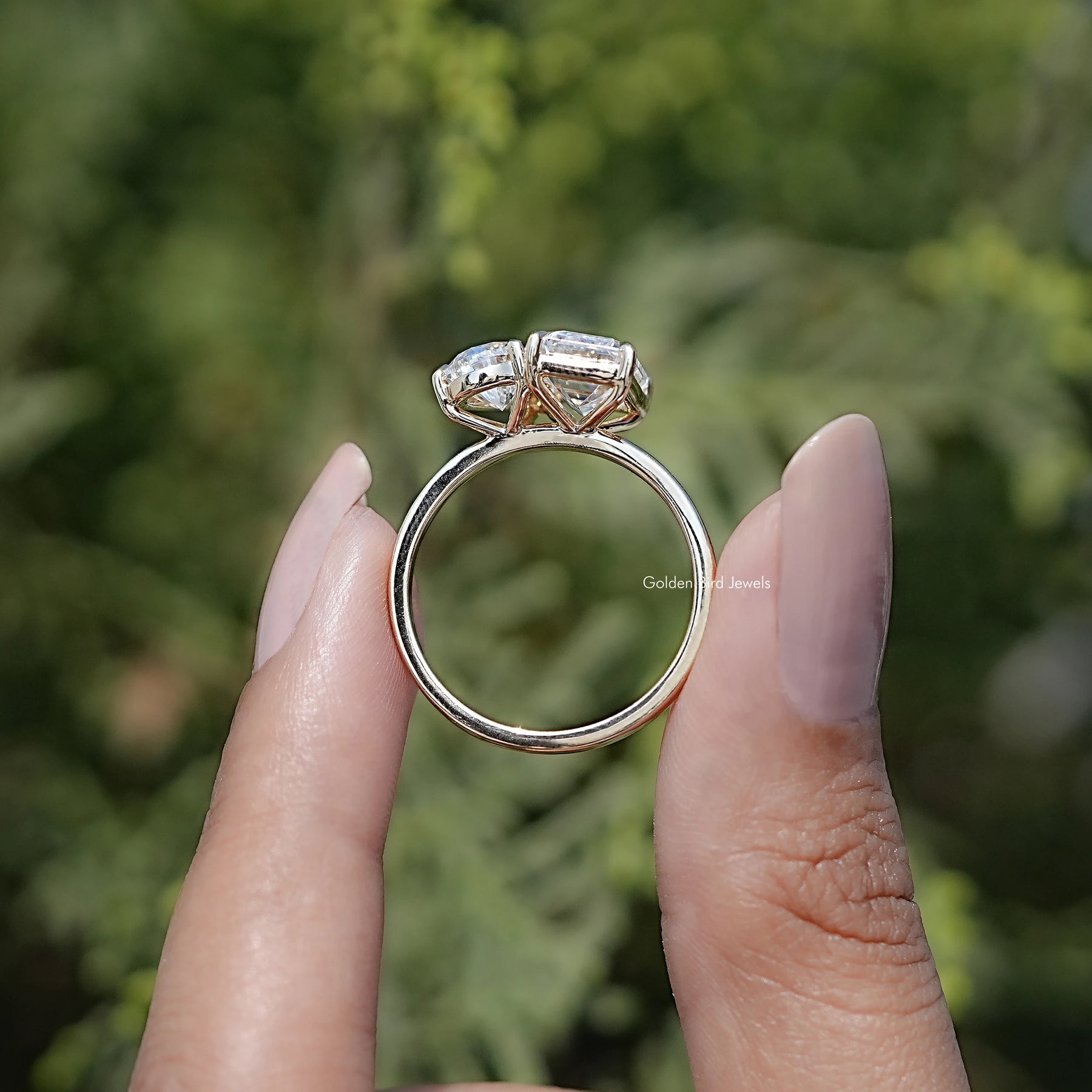 Back view of Pear And Emerald Cut Moissanite Solitaire Ring in secure setting