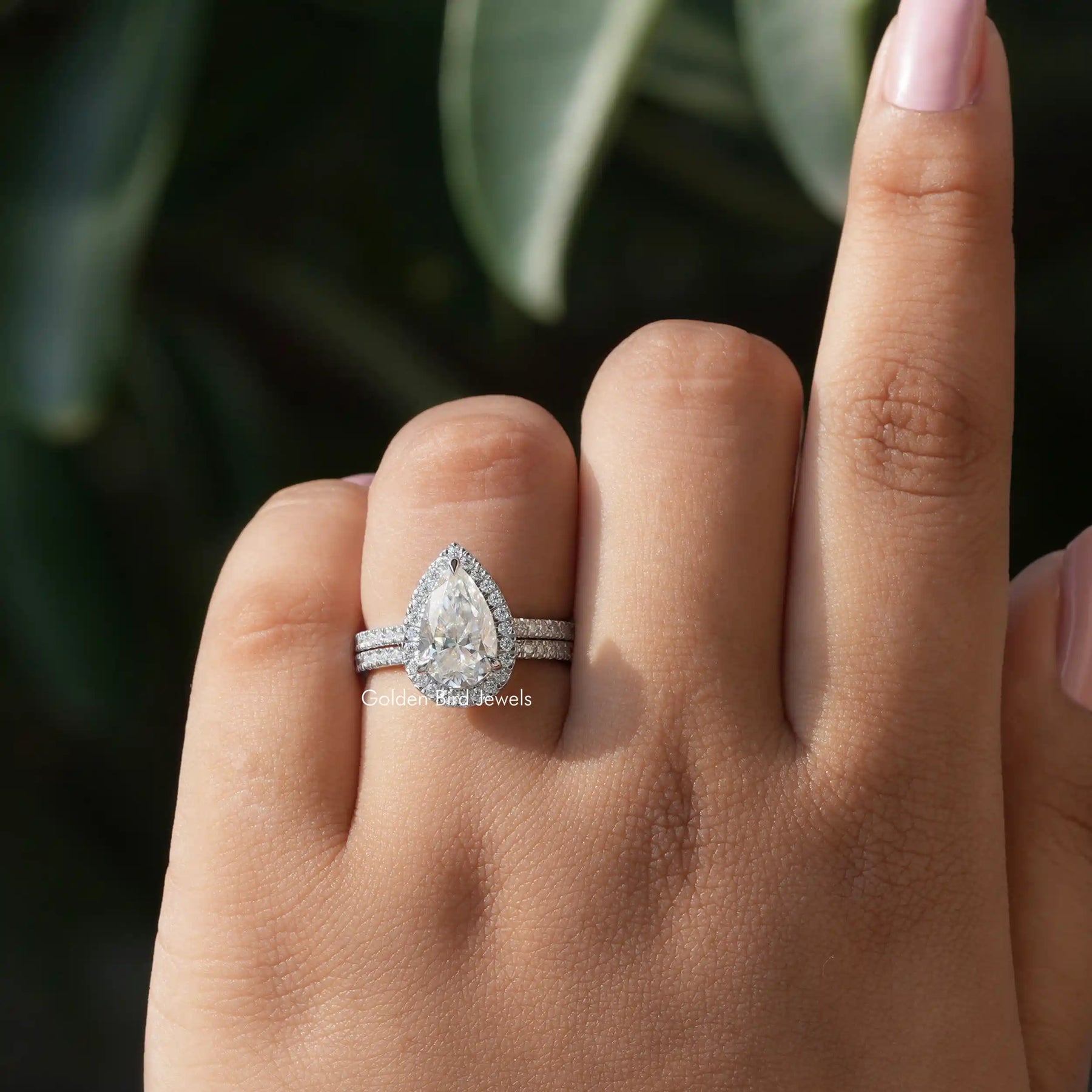 In finger view of Moissanite pear cut bridal ring set in white gold