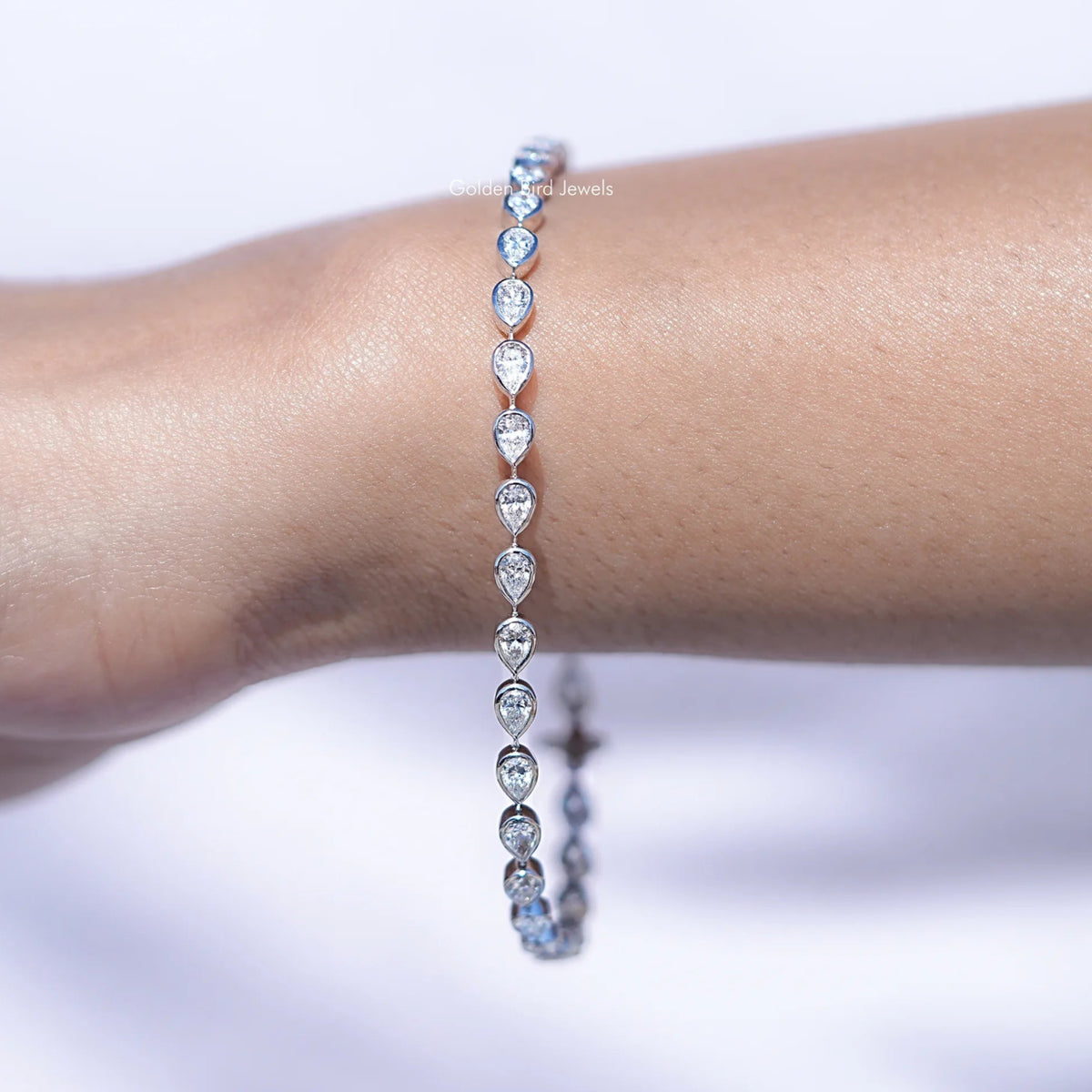 Diamond bracelet on a wrist with a blurred background