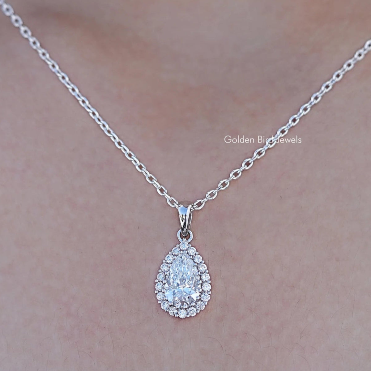 Close up view of Lab Grown Pear Cut Halo Pendant In White Gold