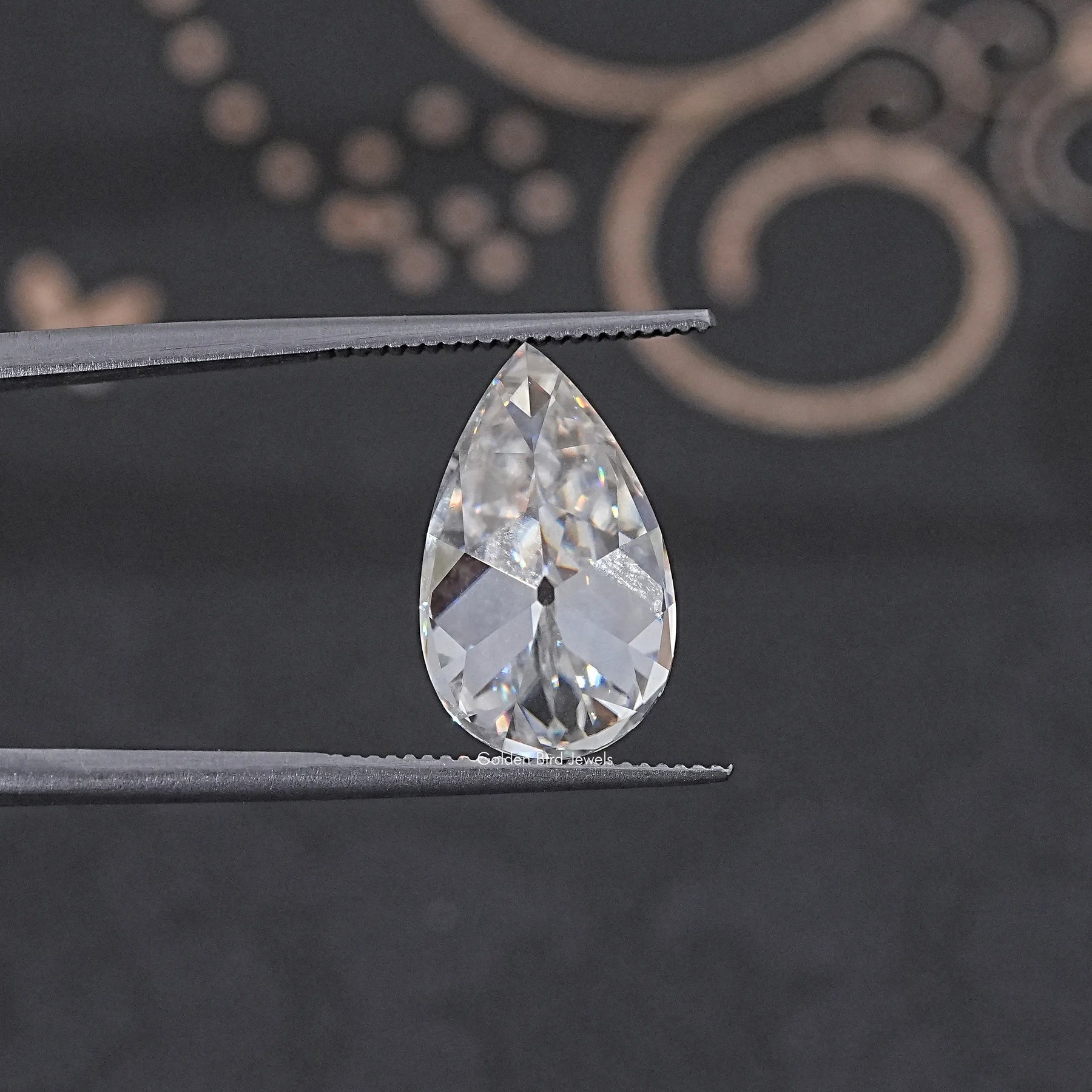 In Tweezer View Of Old Mine Pear Cut Loose Moissanite Stone