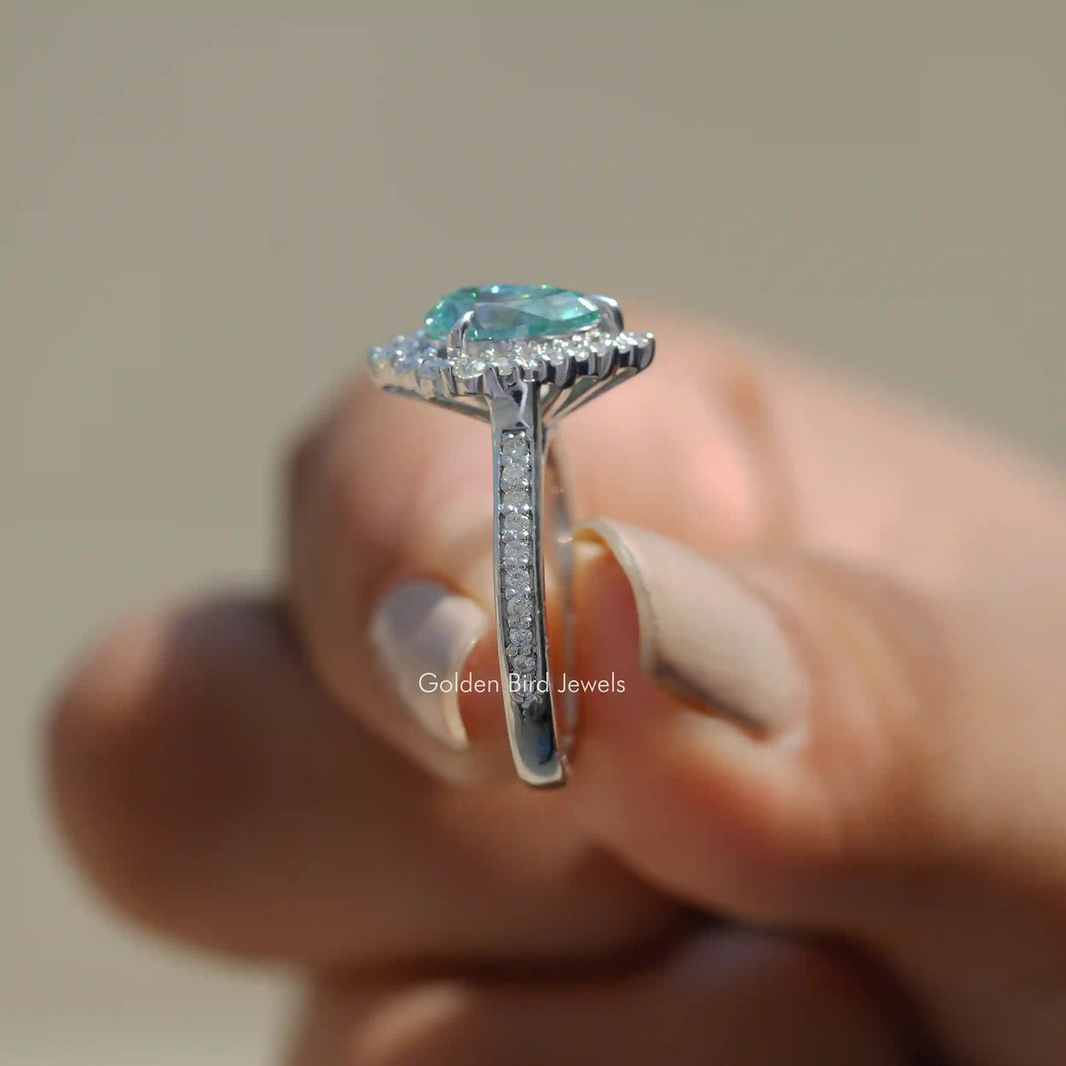 Side View of Pear Cut Moissanite Engagement Ring Set In Prongs In finger