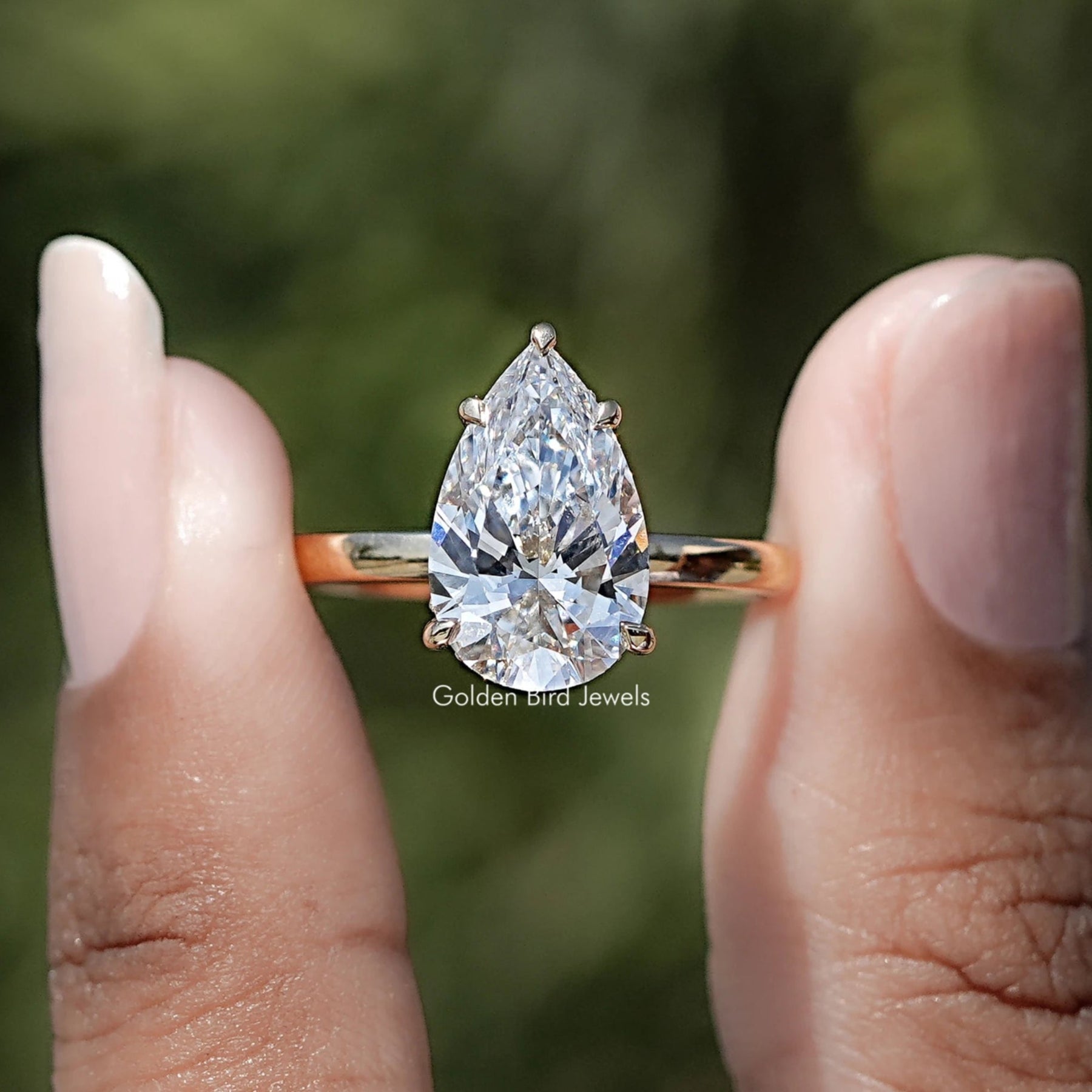 Pear Shaped Lab Diamond Hidden Halo Ring Between Two Fingers