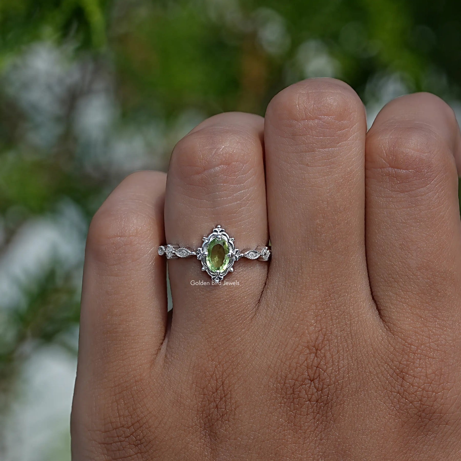 Profile View of Green Oval And Colorless Round Cut Accent Ring