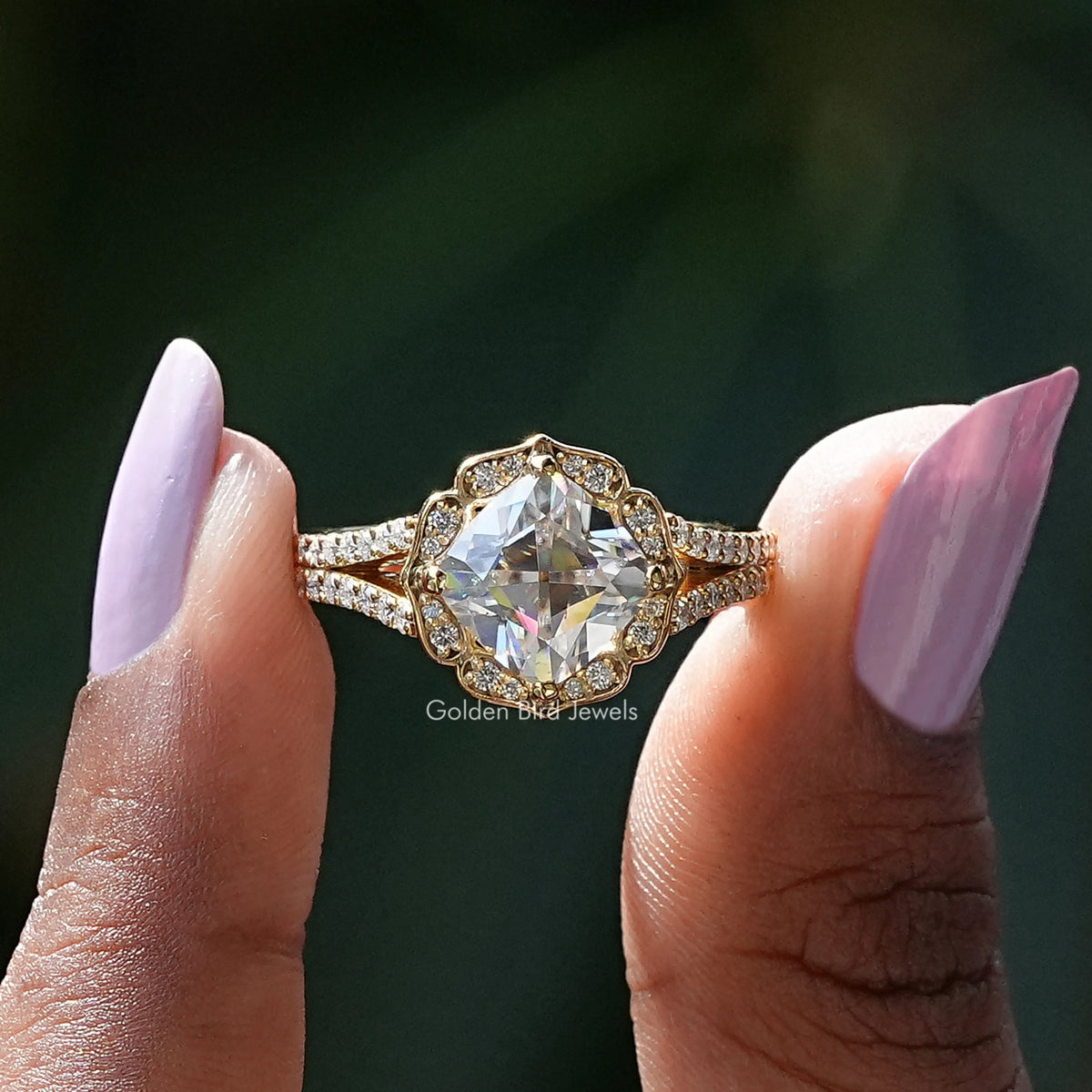 Two fingers holding the Peruzzi Cut Moissanite Halo Split Shank Ring