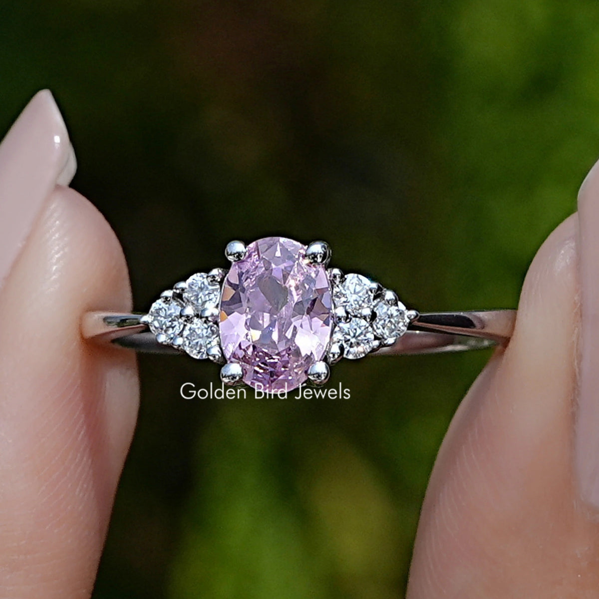 Front view of Pink Tourmaline Oval Gemstone Engagement Ring in two fingers