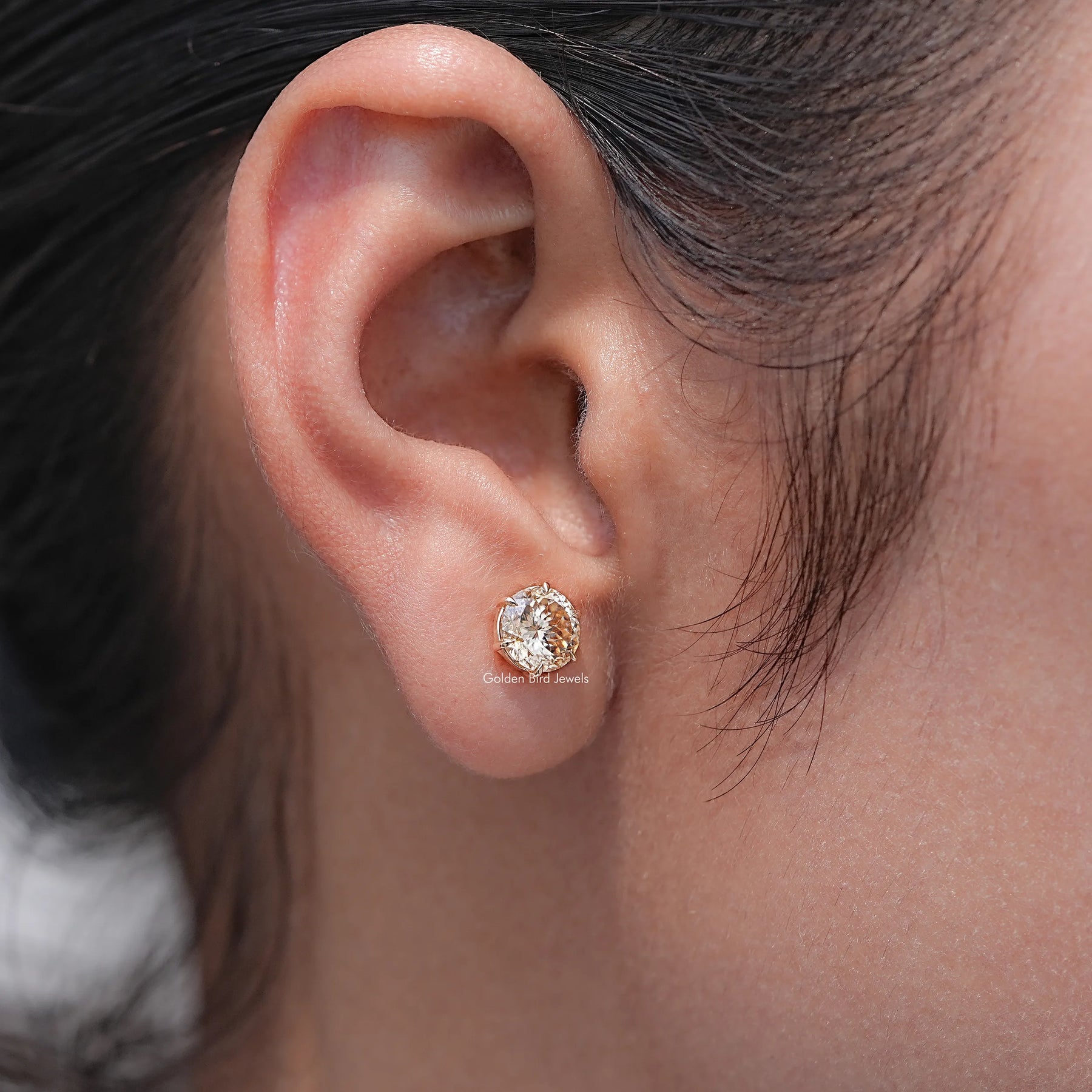 Detailed view of Round Cut Moissanite Stud Earrings in secure setting