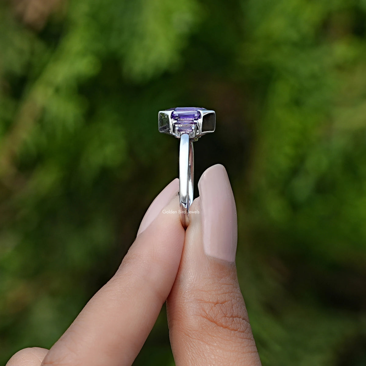 Side View of Amethyst Hexagon Gemstone Accent Ring In two fingers