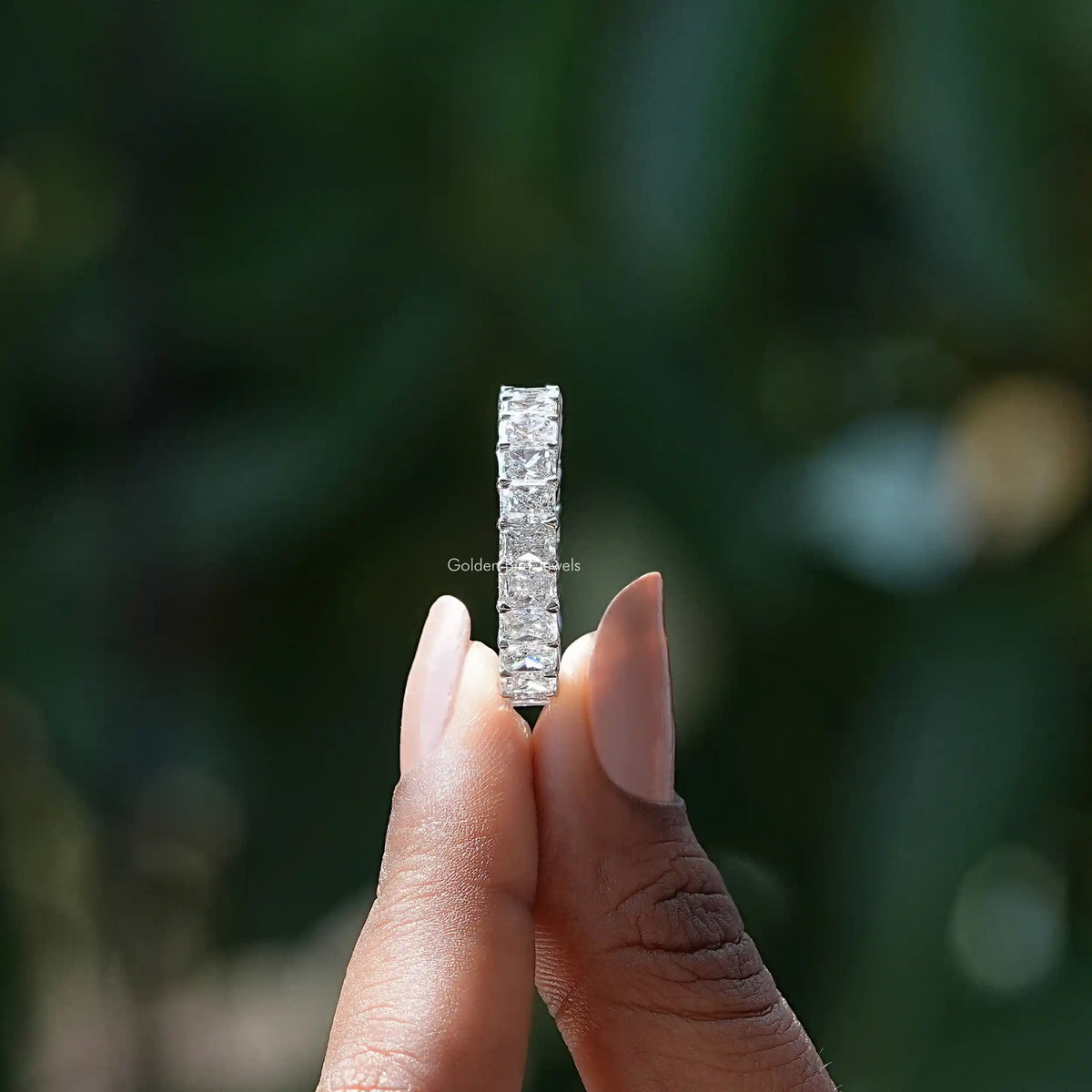 Side View of Radiant Cut Diamond Eternity Wedding Band In two fingers