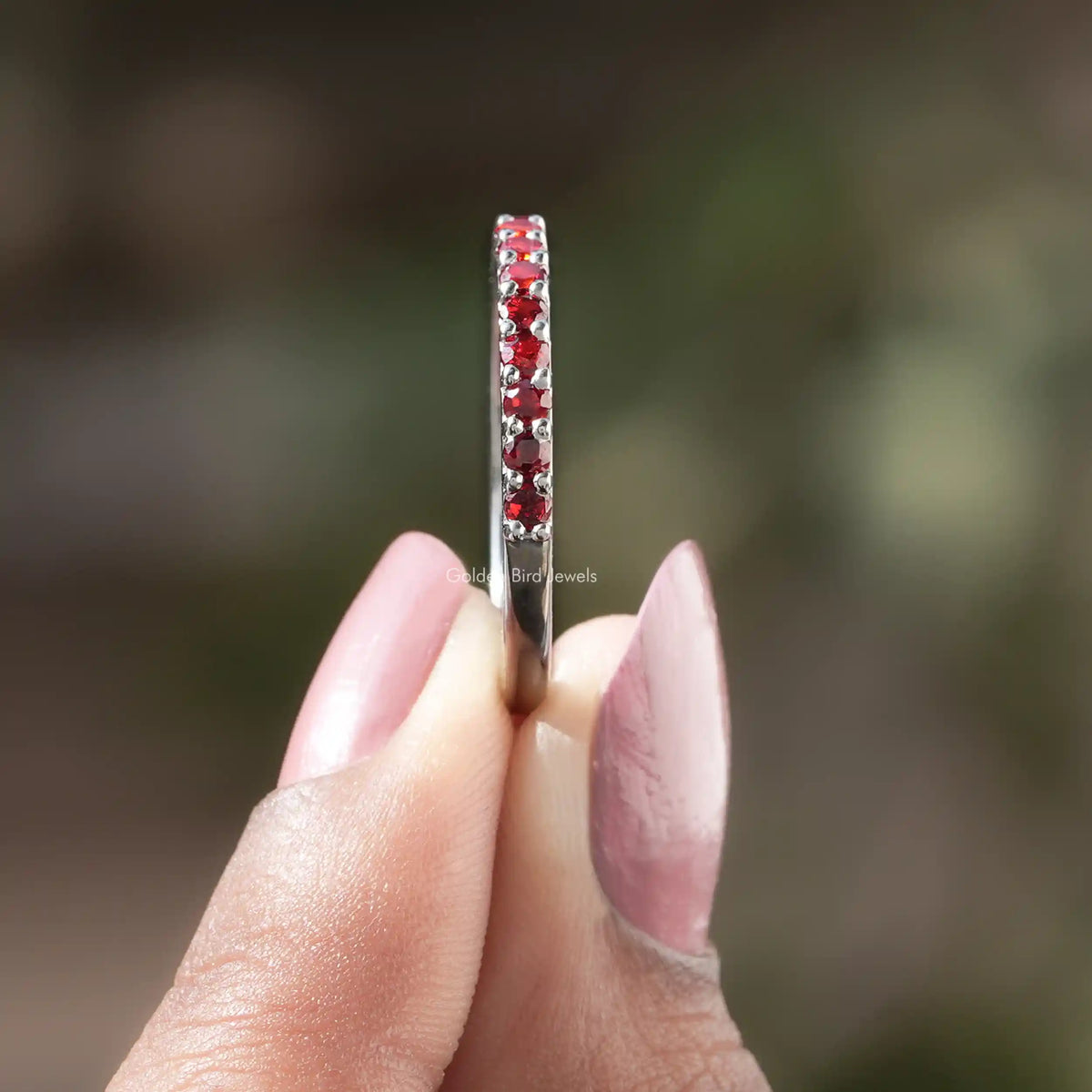 Side view of Red Garnet Round Gemstone Half Eternity Band