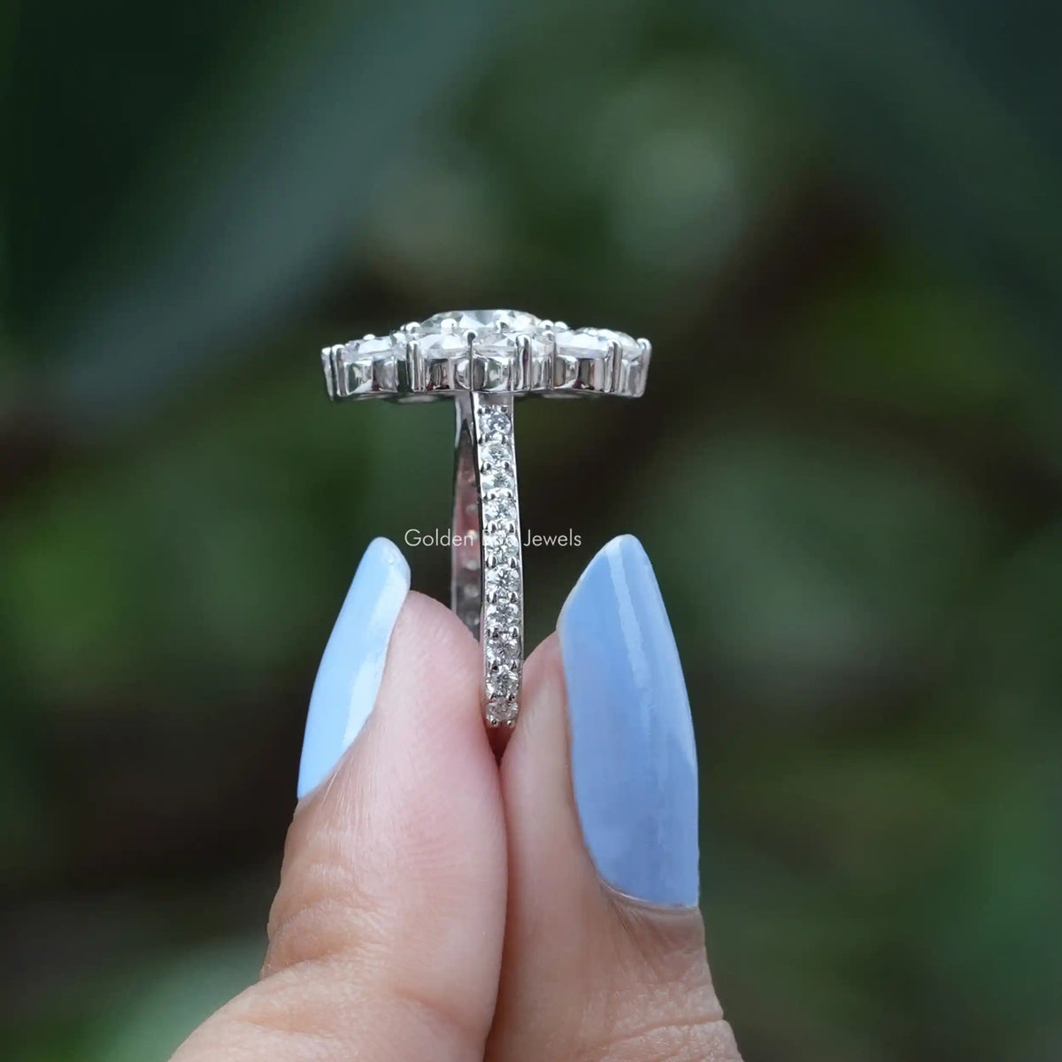 Side View of Round Cut Moissanite Floral  Engagement Ring In two fingers