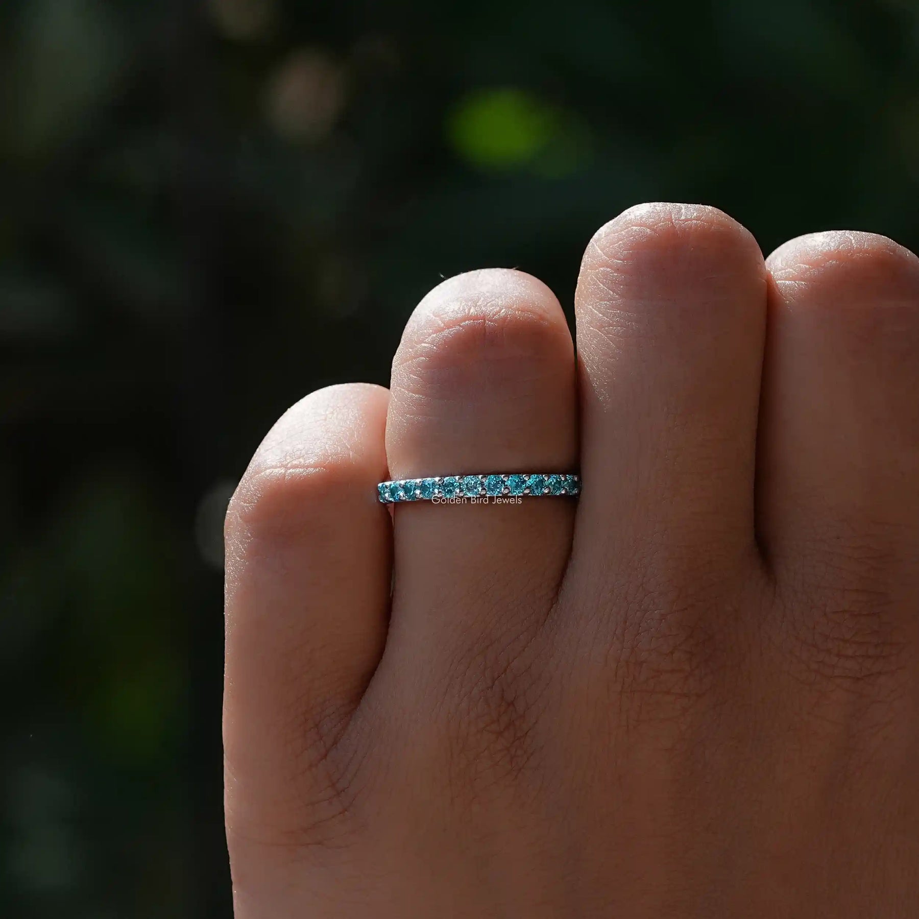 View of Blue Topaz Round Eternity Band in prongs setting