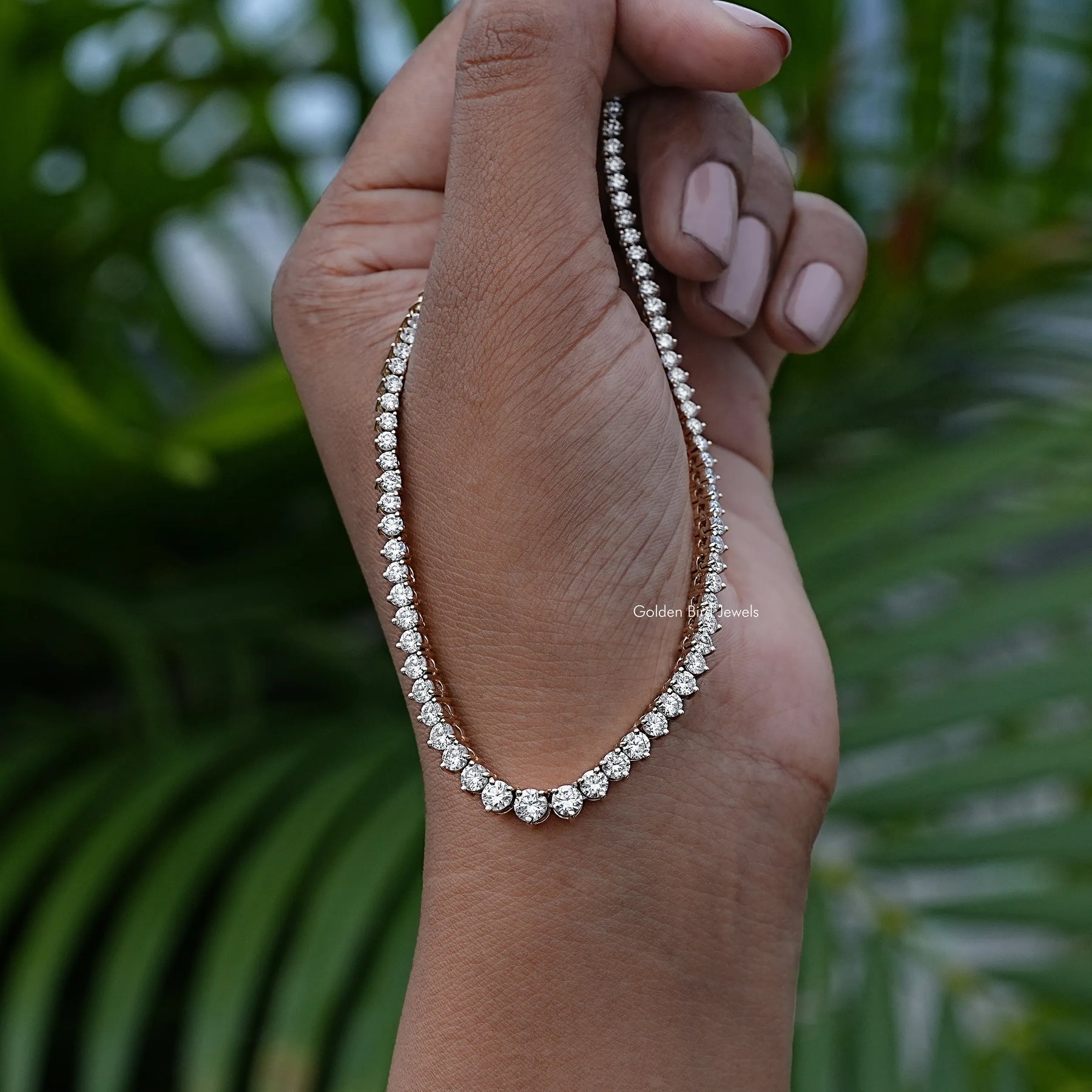 In Hand Showing View Of Round Shaped Tennis Necklace