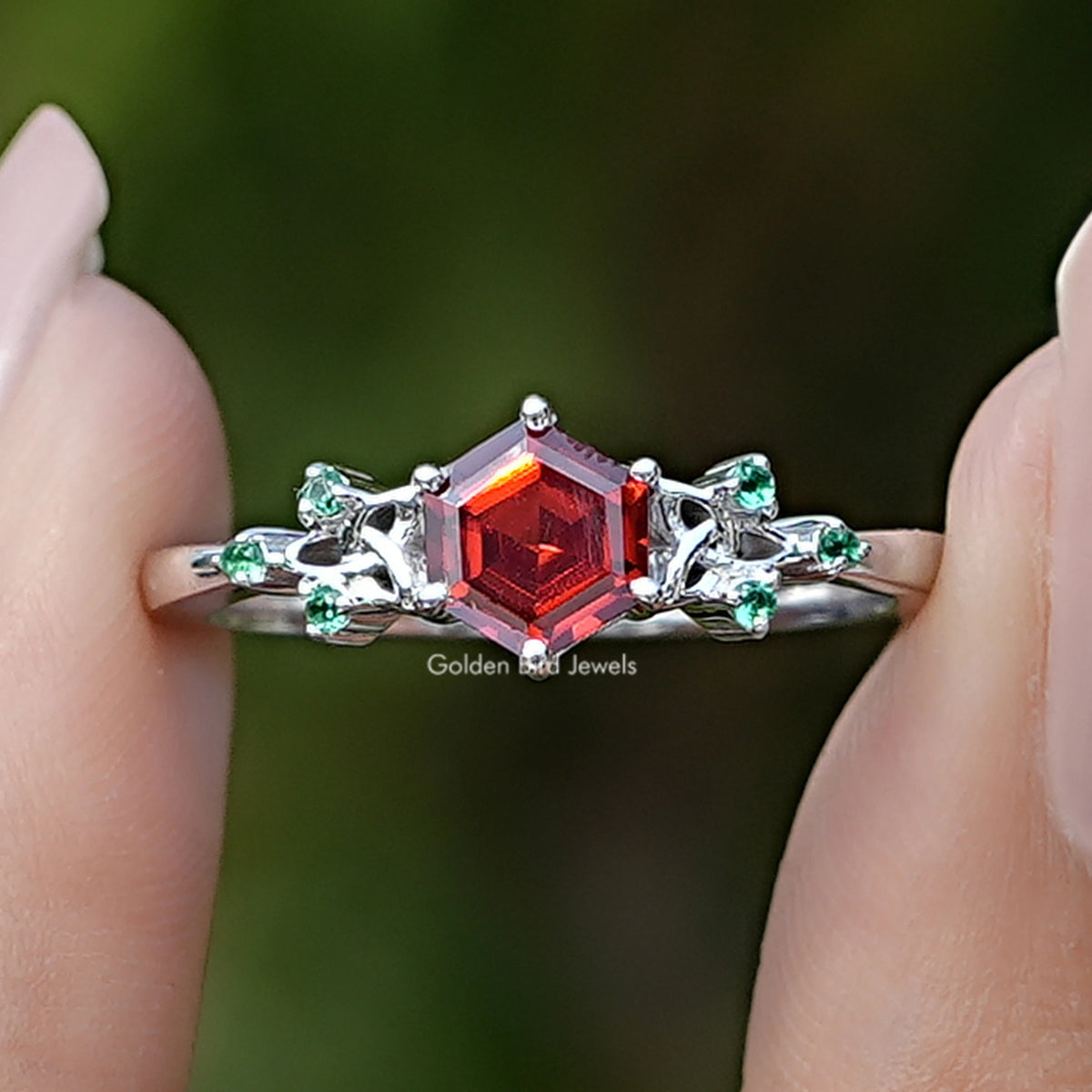 Front view of Sunstone Hexagon Cut Gemstone Accent Ring Set in two fingers
