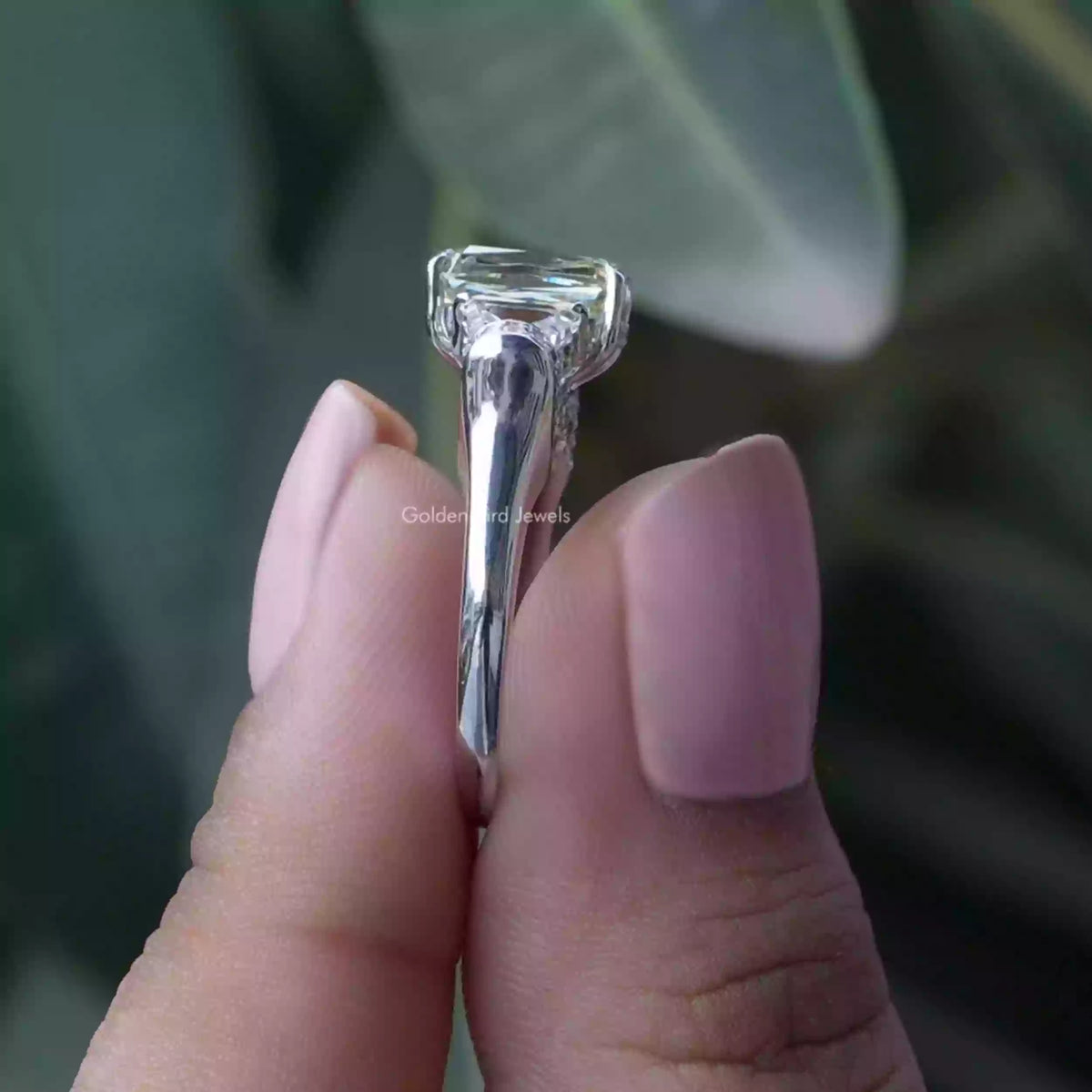 Side View of Criss And Trapezoid Moissanite Ring In two fingers
