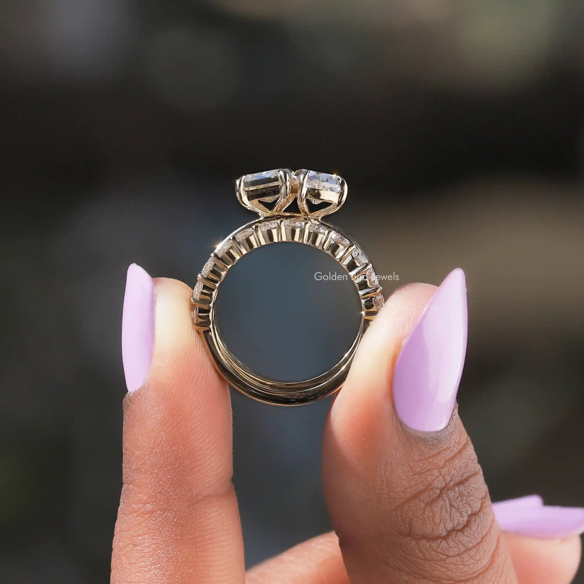 Back View of Criss and Old Pear Cut Moissanite Ring In two fingers