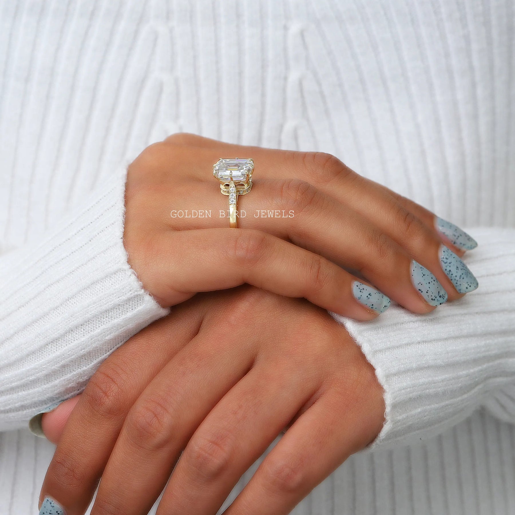In a finger Side view of a moissanite halo engagement ring