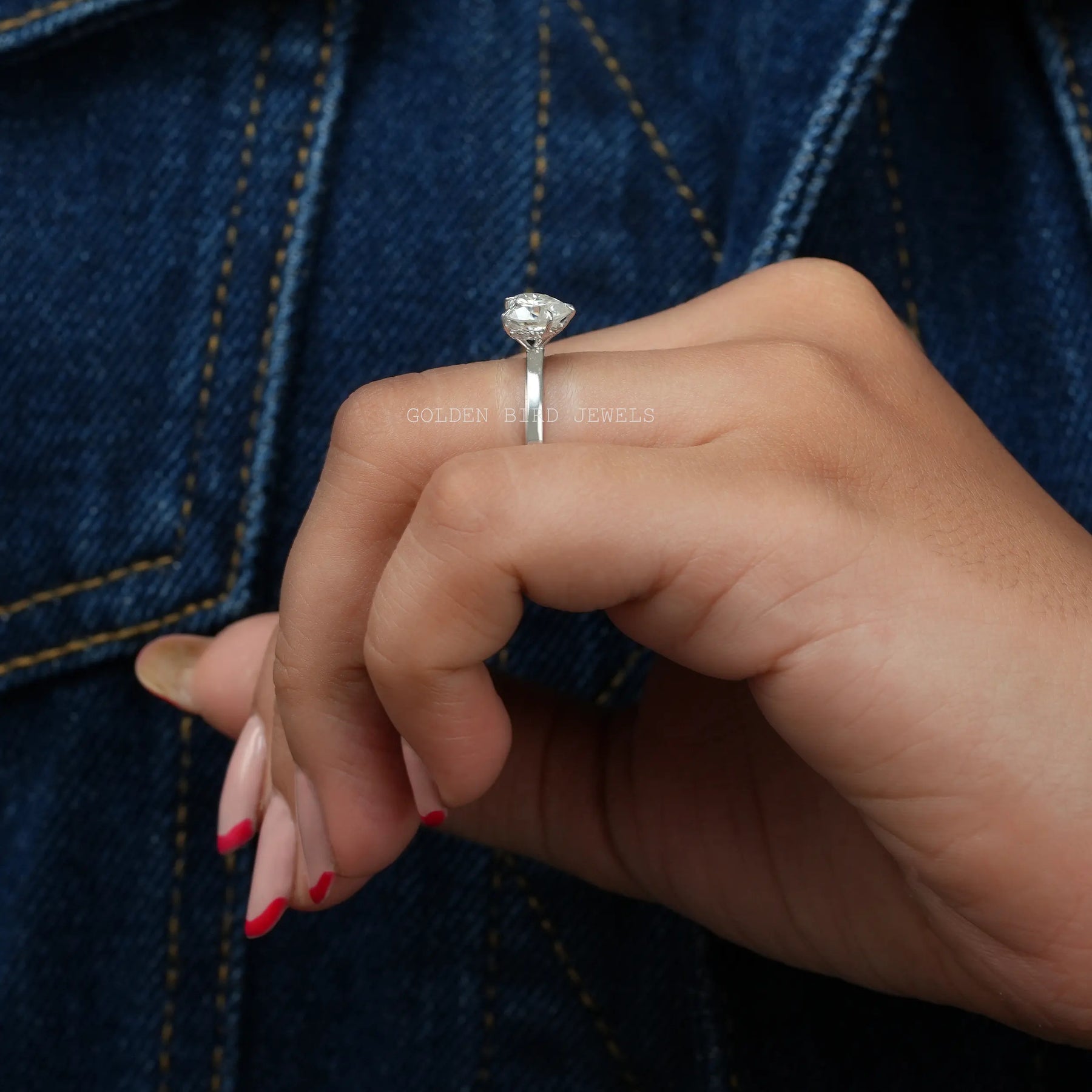 finger side view of moissanite solitaire with hidden halo engagement ring