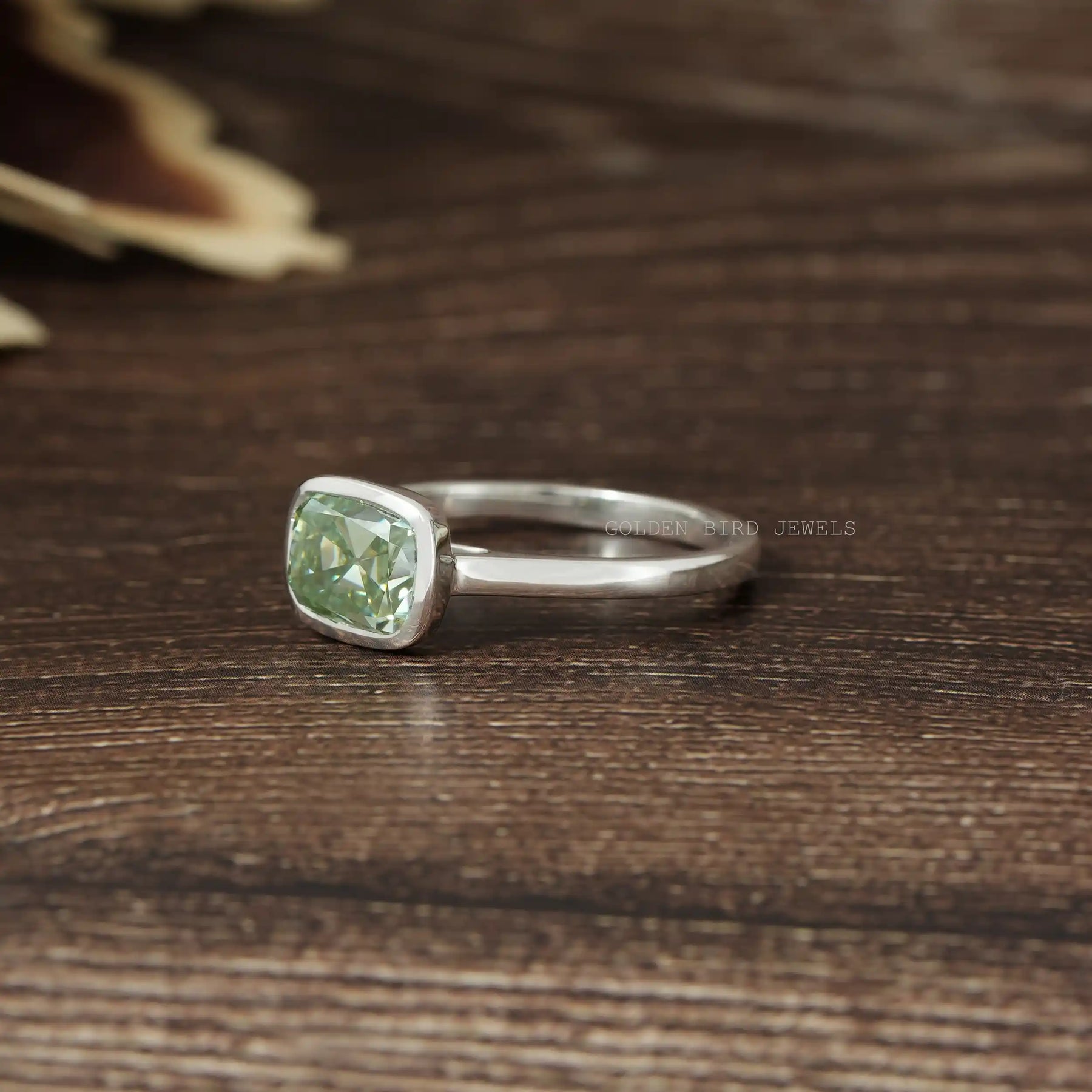 Left Side View Of Old Mine Cushion Cut East West Bezel Set Moissanite Engagement Ring