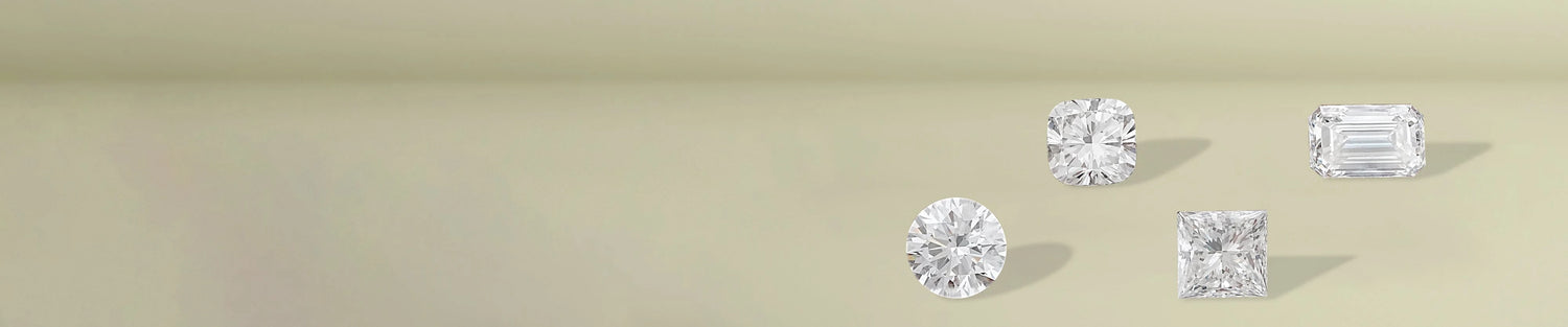 Round brilliant cut diamonds displayed on soft beige fabric surface