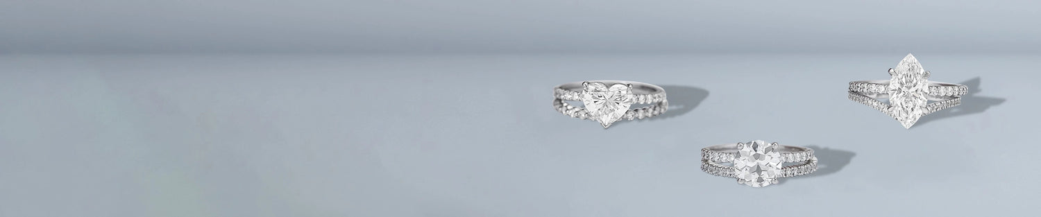 Lab grown bridal ring sets with round and cushion diamonds on light blue background