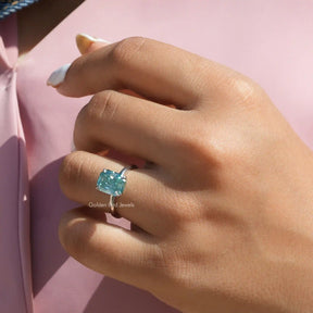 [In finger front view of blue radiant cut moissanite ring made of four prongs]-[Golden Bird Jewels]