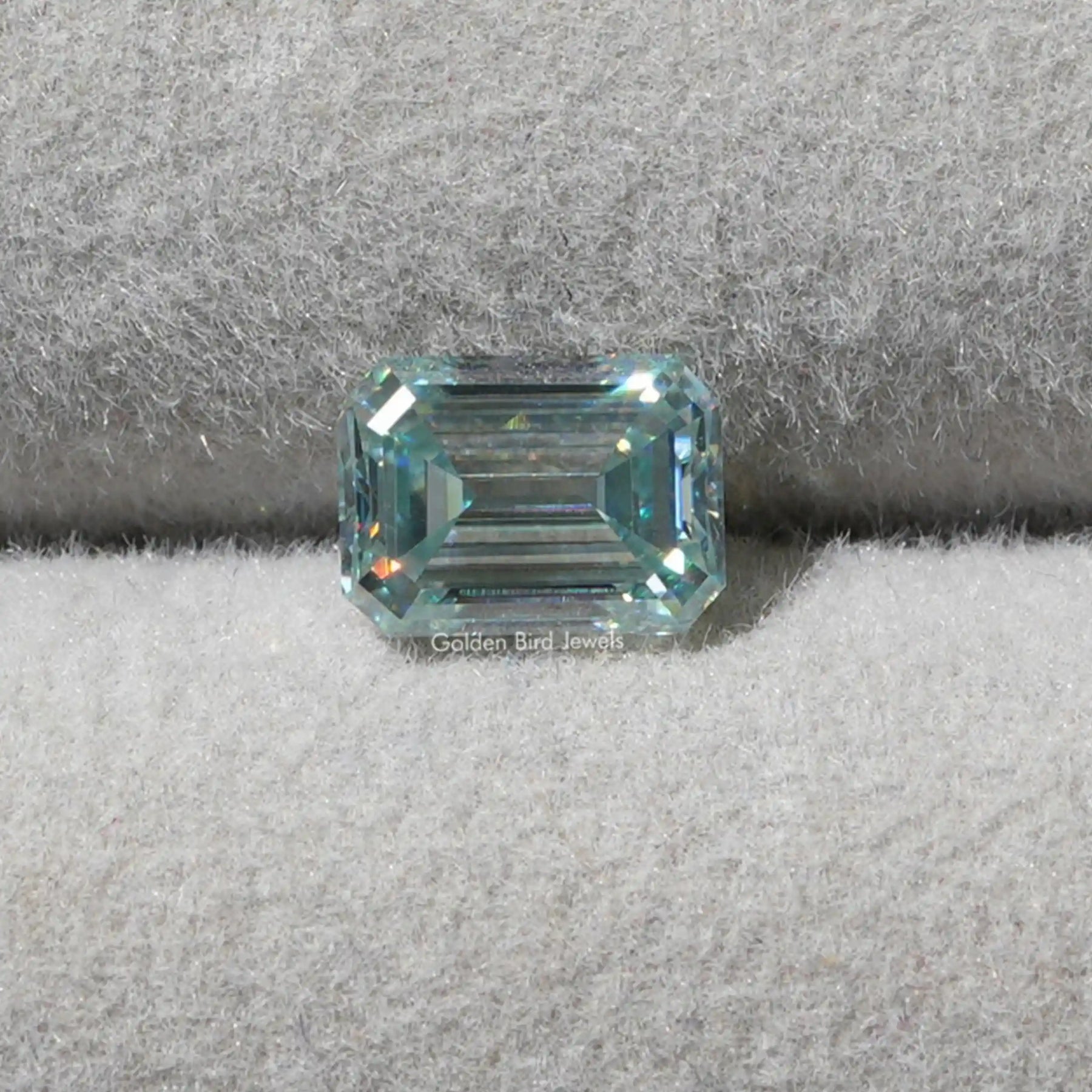 [Front view of aqua blue emerald cut loose moissanite made of vs clarity]-[Golden Bird Jewels]