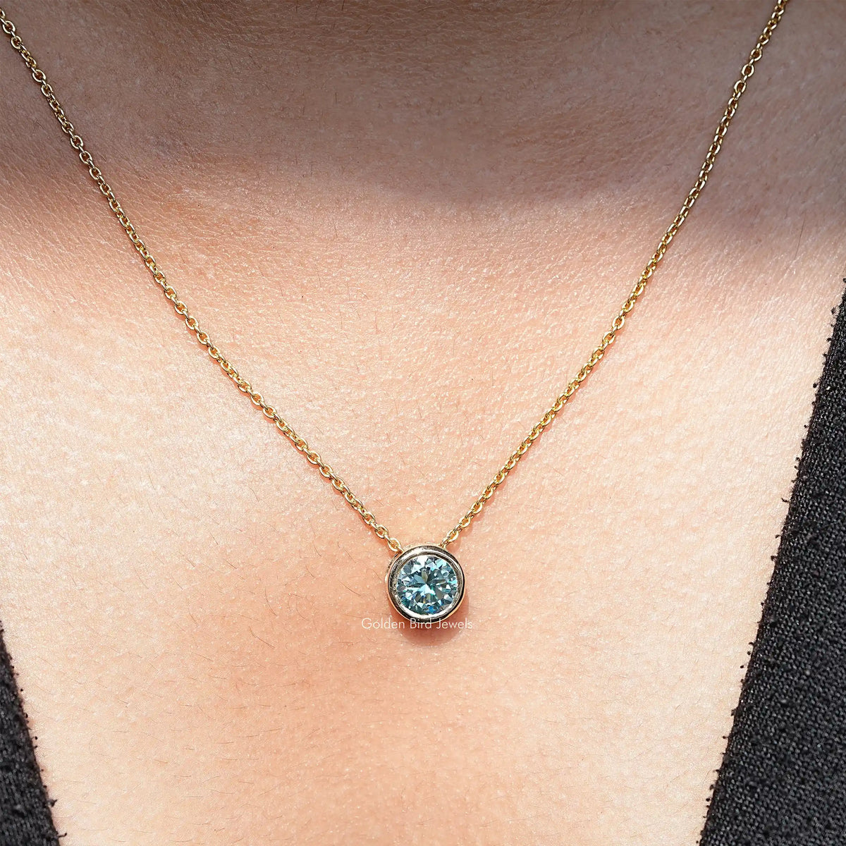 View of round cut moissanite solitaire pendant 