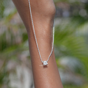 In hand showing view of diamond pendant	in secure setting
