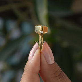 Side View of Asscher Cut Lab Diamond Three Stone Ring In two fingers