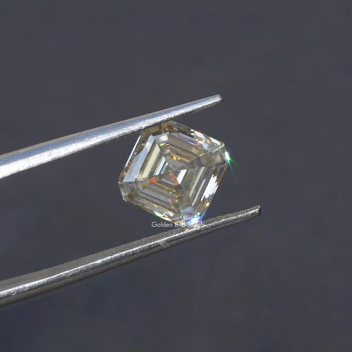 Tweezer holding the White Asscher Cut Moissanite Loose Stone