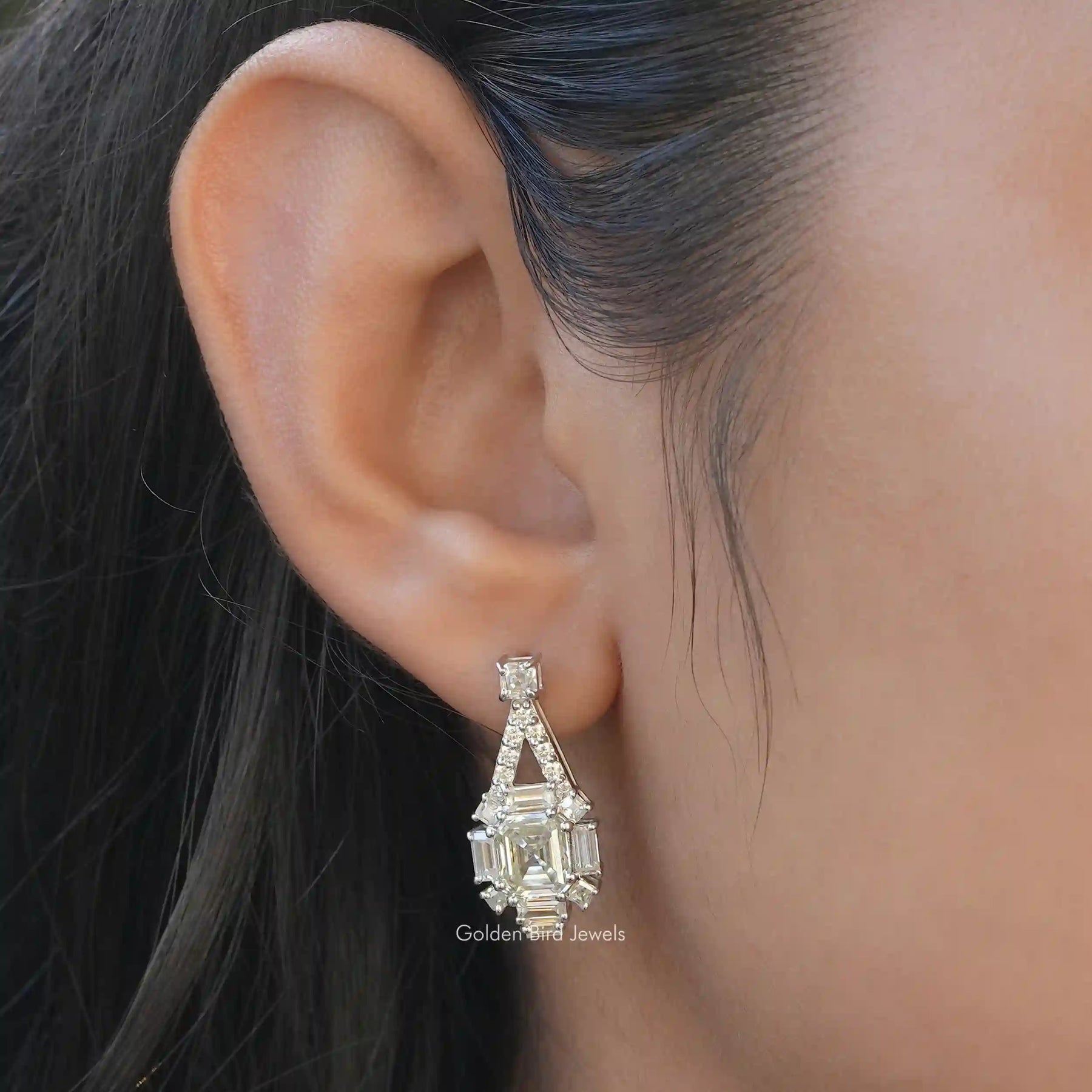 [This dangle earrings set in asscher cut stone and white gold]