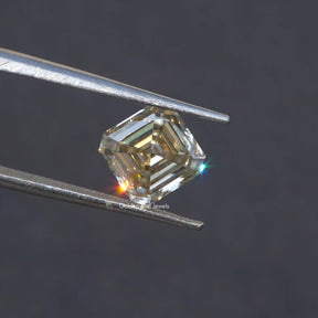 Tweezer holding the Off White Asscher Cut Loose Moissanite