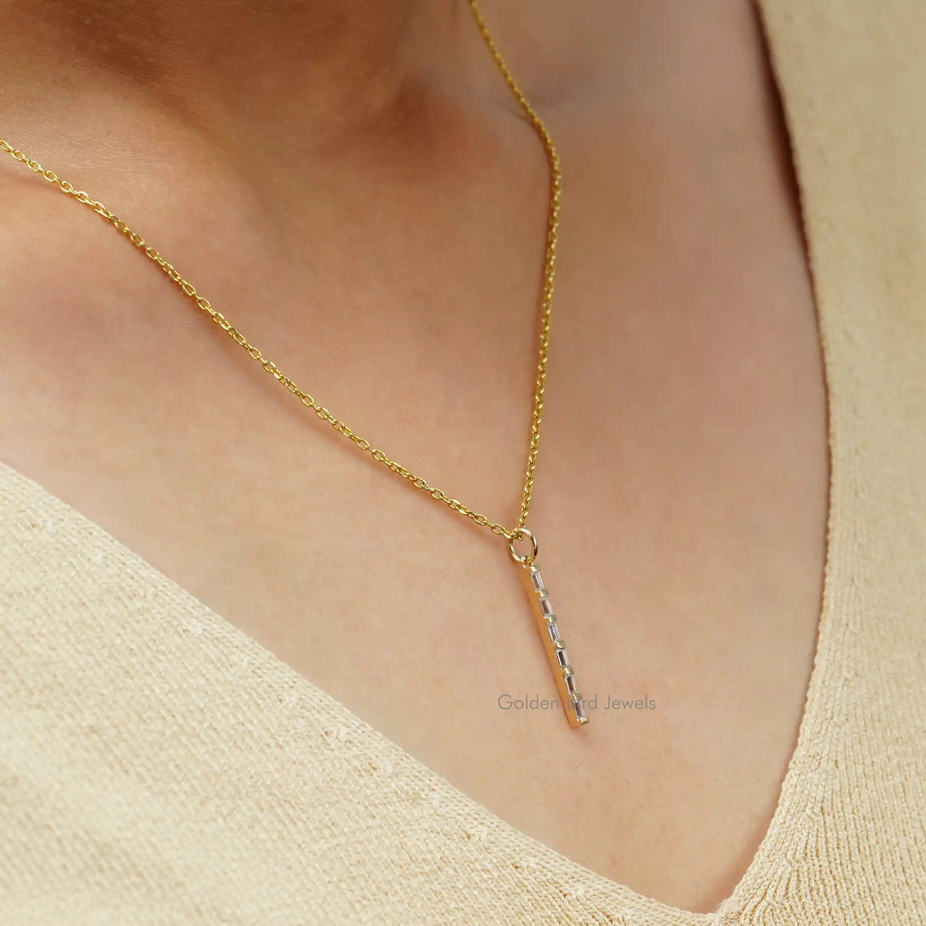 [In neck side view of baguette cut vertical minimalist bar pendant in 14k yellow gold]-[Golden Bird Jewels]