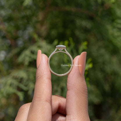 Oval moissanite solitaire ring back view, bezel-set stone with slim gold band