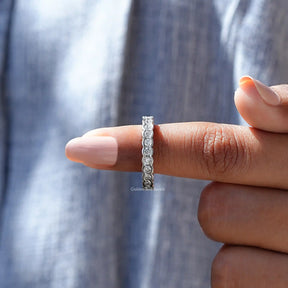 In finger front View of Round Cut Bezel Set Wedding Band In White Gold