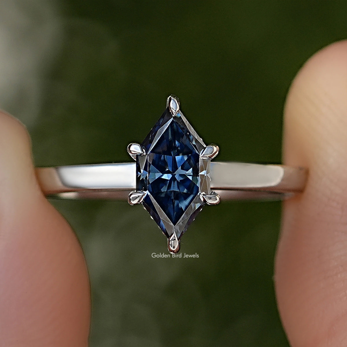 Blue marquise-cut gemstone ring with 4-prong setting on silver band