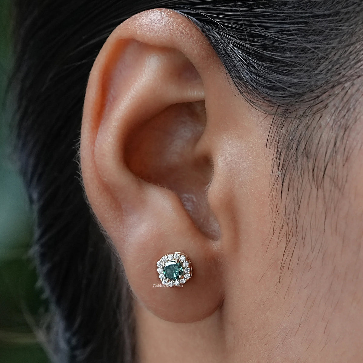 In ear view of blue cushion cut cluster moissanite earrings