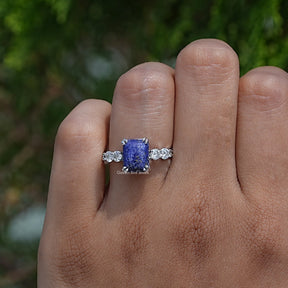 Close-Up View of Double Prong Emerald Cut Engagement Ring In White Gold