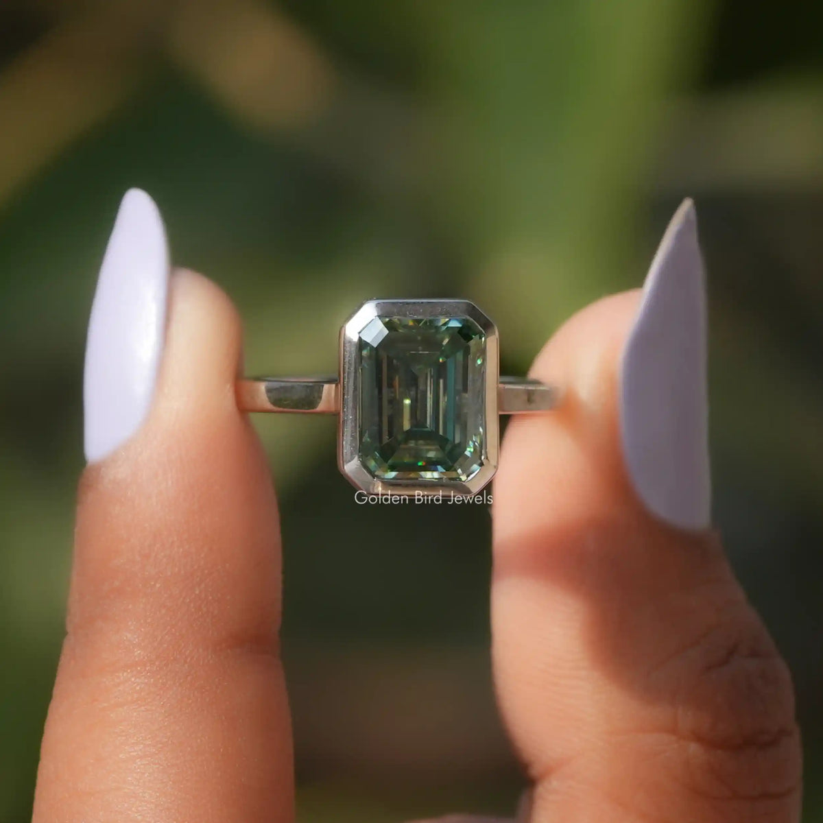Front View Of Green Emerald Cut Moissanite Solitaire Ring on a two fingers