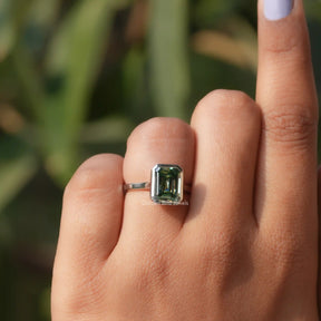 Front View Of Green Emerald Cut Moissanite Solitare Ring In a Finger