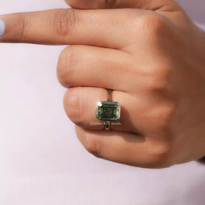 Clear View of Green Emerald Cut  Solitare Ring In a finger